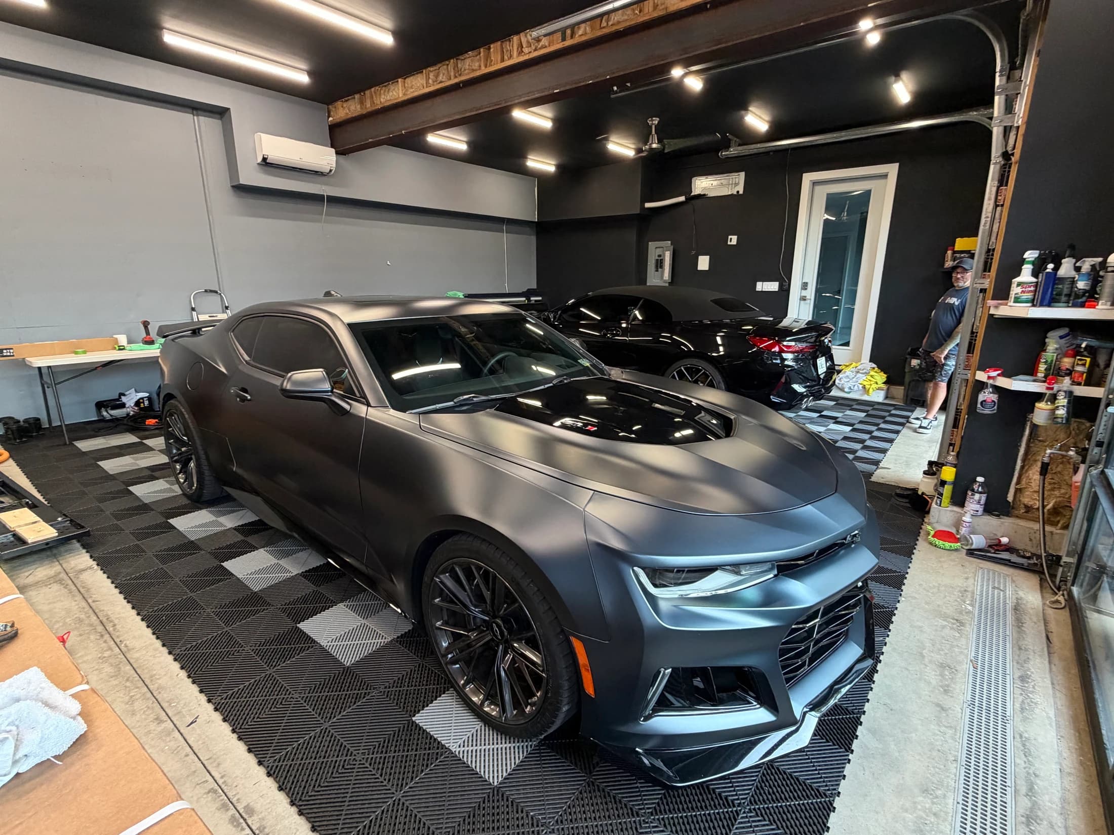 Three-quarter view of a satin gray Camaro ZL1 in the studio