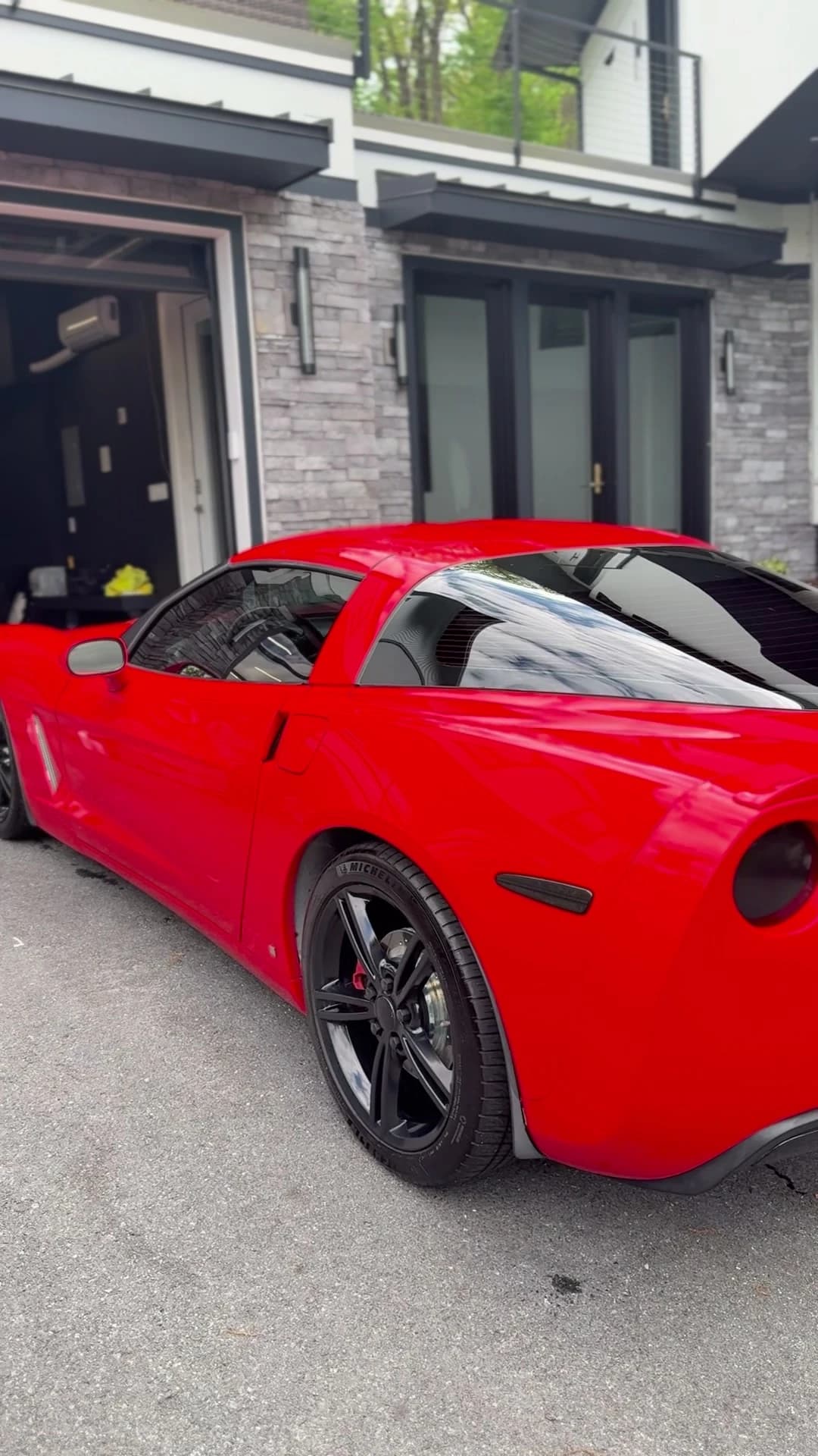 Glossy red Corvette C6 rear quarter and wheel after polishing