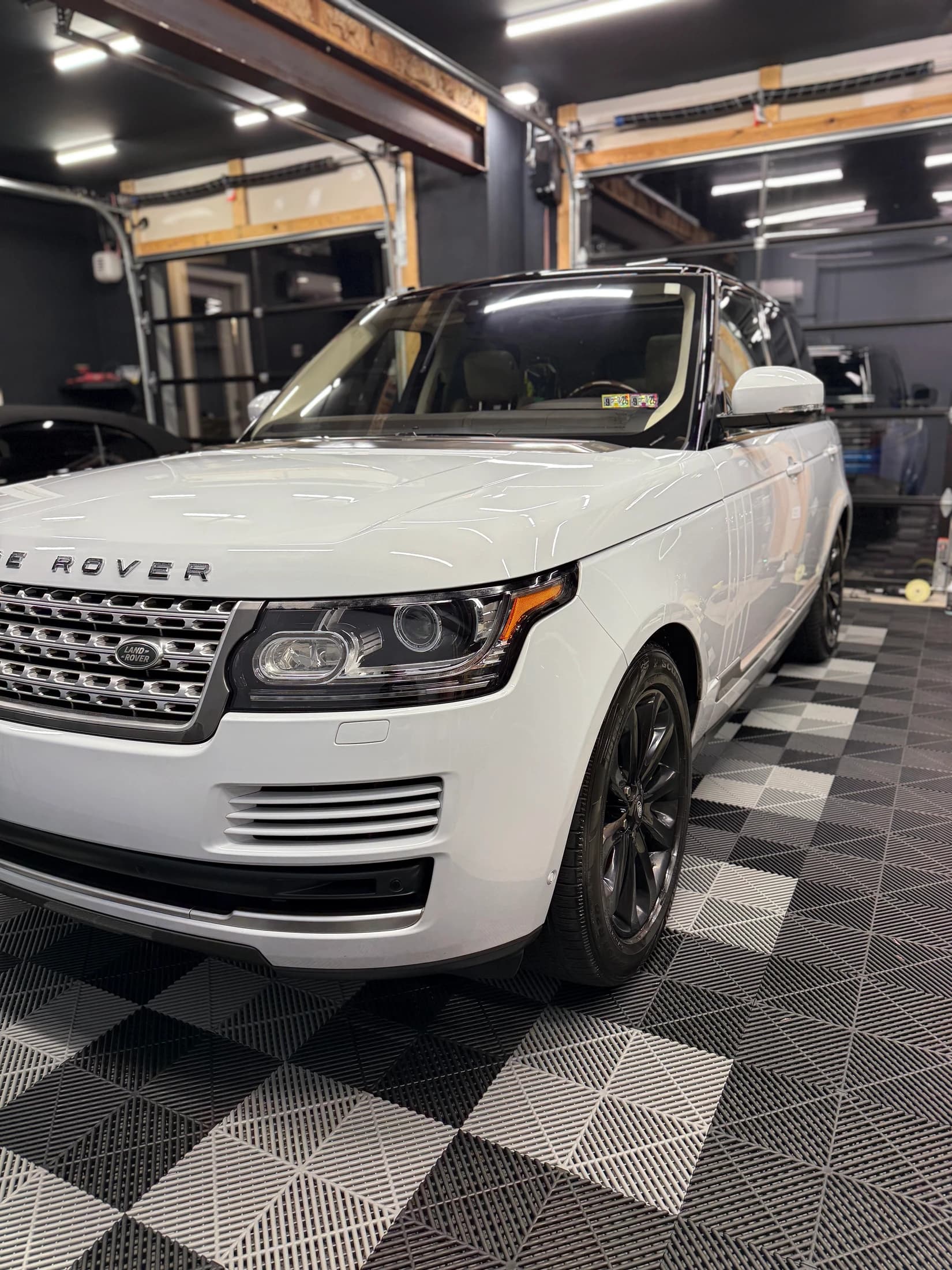 White Range Rover with reflective paintwork in the detailing studio